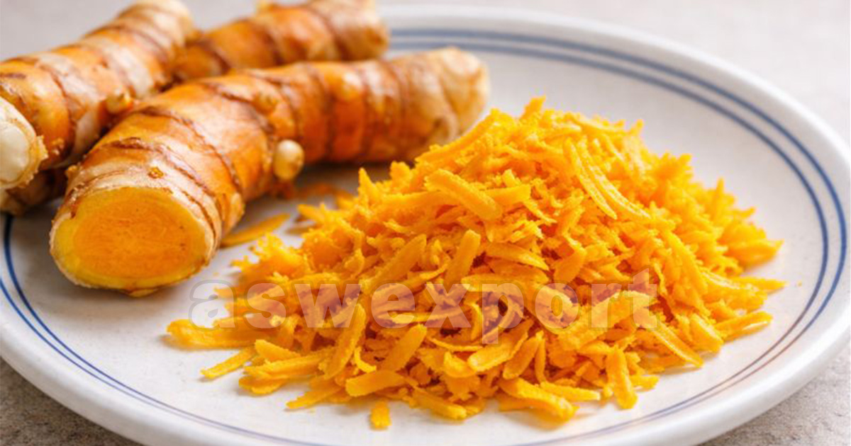 Fresh turmeric root and grated turmeric on a plate, natural spice ingredient